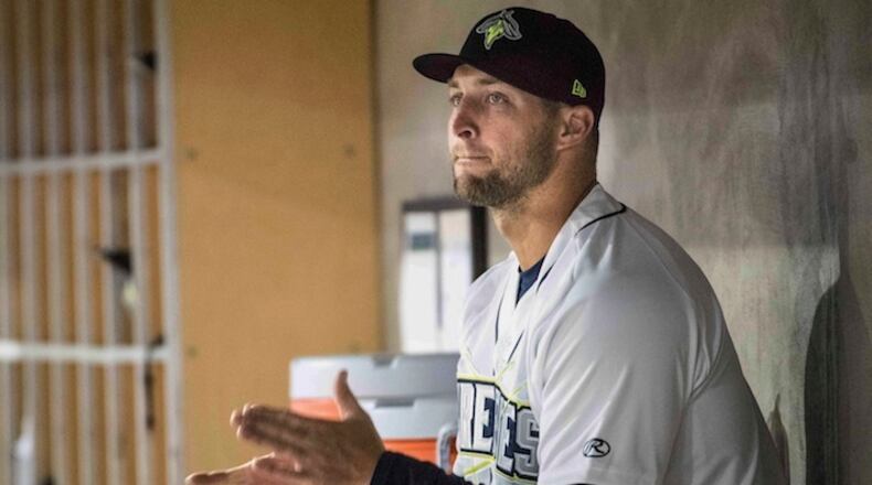 Columbia Firefly outfielder Tim Tebow applauds from the dugout during a Class A minor league baseball game against the Augusta GreenJackets Thursday, April 6, 2017, in Columbia, S.C. Columbia defeated Augusta 14-7. (AP Photo/Sean Rayford)