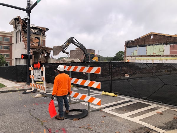 A work crew demolishes the Saye Building in downtown Athens on Thursday, July 31, 2025. The 1920s structure had housed automobile-related businesses, a bus company, a business college and law offices. (Jim Thompson for the AJC)