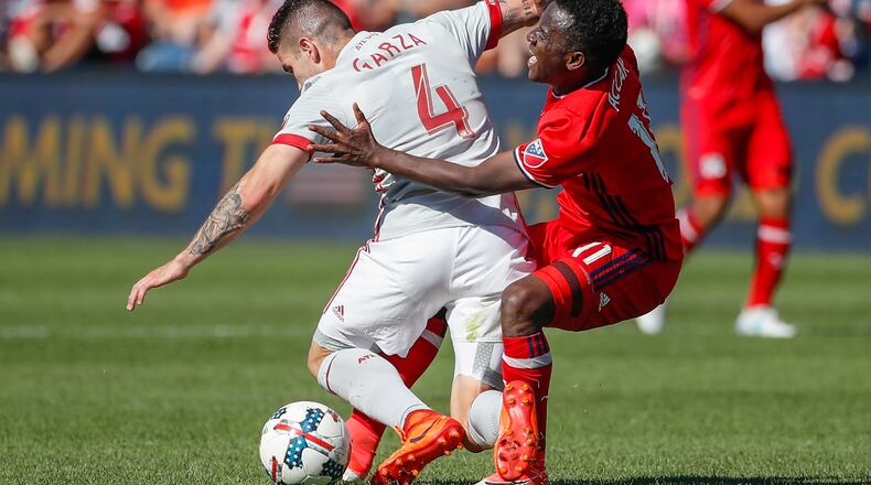 Atlanta United defender Greg Garza, left, tries to keep the ball away from Chicago Fire forward David Accam during the second half of an MLS soccer match, Saturday, June 10, 2017, in Bridgeview, Ill. (AP Photo/Kamil Krzaczynski)