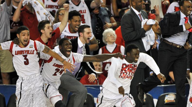 The Louisville Cardinals celebrate their win over the Michigan Wolverines.