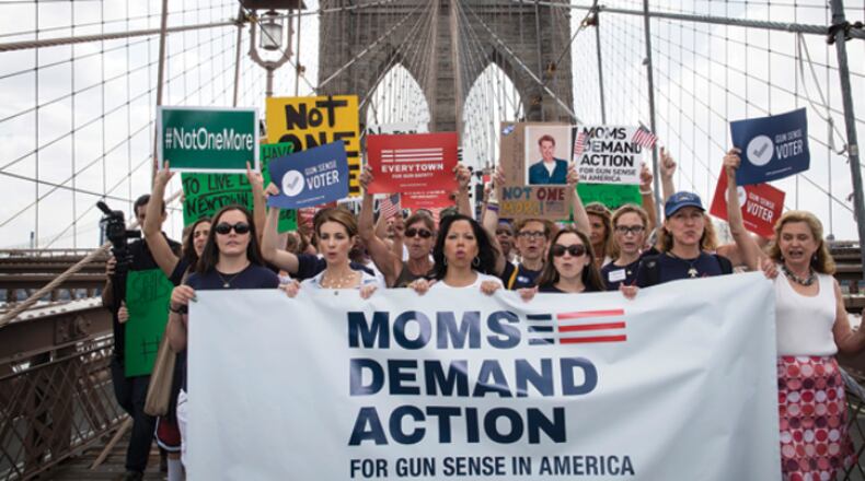 Lucy McBath (center) and others demand more be done to halt gun violence.