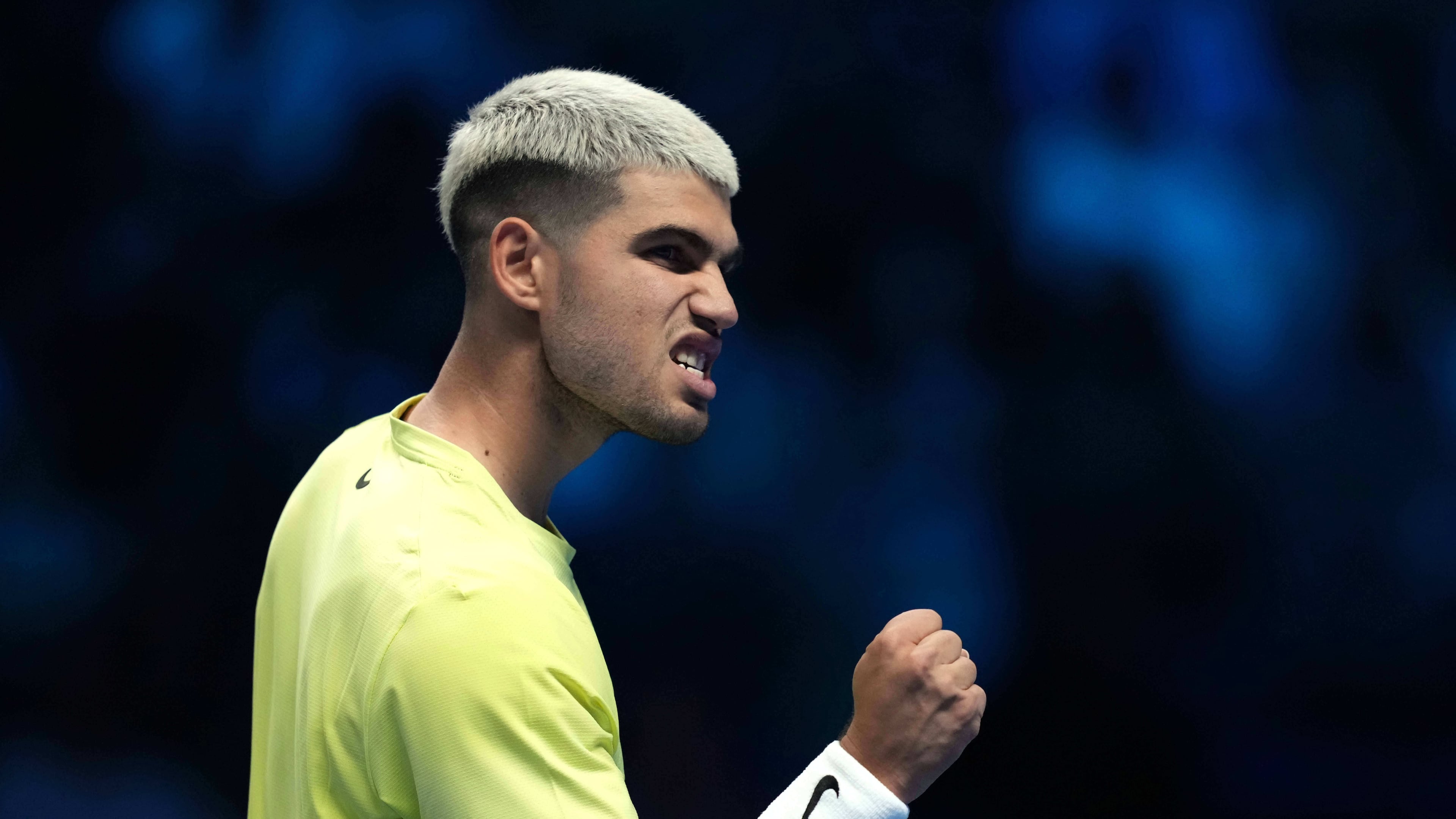 Spain's Carlos Alcaraz reacts after winning a point against Australia's Alex de Minaur during their singles tennis match of the ATP World Tour Finals, in Turin, Italy, Sunday, Nov. 9, 2025. (AP Photo/Antonio Calanni)