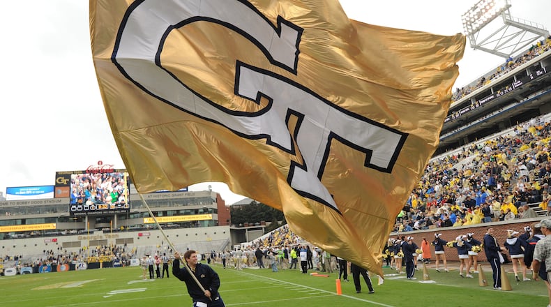 A Georgia Tech cheerleader waves the giant Tech flag following a touchdown.
