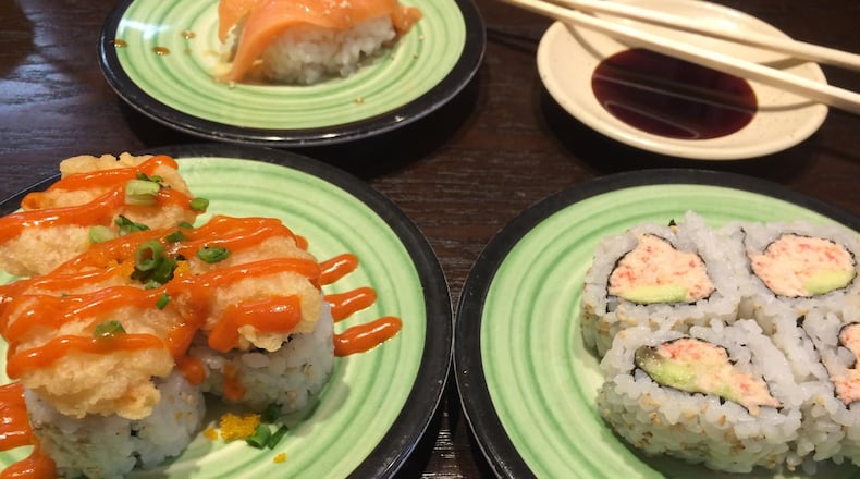 The Spicy Popcorn Shrimp Roll and the Real Crab California Roll are among the options at Kula Revolving Sushi Bar in Doraville. In the back is the Garlic Ponzu Salmon Nigiri. CONTRIBUTED BY WENDELL BROCK
