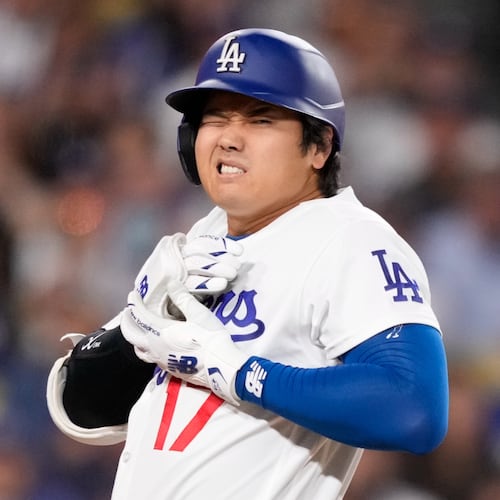 Los Angeles Dodgers' Shohei Ohtani reacts after being hit by a pitch during the fourth inning of a baseball game against the Colorado Rockies, Tuesday, May 26, 2026, in Los Angeles. (AP Photo/Mark J. Terrill)