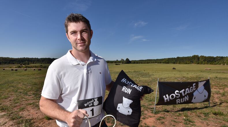October 13, 2016 Hampton - Mike Harris, organizer of the Hostage Run, holds a handcuffs cable tie and pillow couch that participant can use during the Hostage Run at Nash Farm Battlefield in Hampton on Thursday, October 13, 2016. Hostage Run was created as a crazy athletic challenge for our hardcore military men and women. But critics say the Hostage Run is distasteful and makes light of the perilous times in global politics with the likes of ISIS and bombings and beheadings and other threats.HYOSUB SHIN / HSHIN@AJC.COM