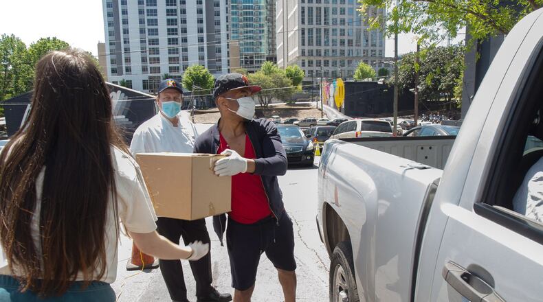 Café Intermezzo-Midtown employees hand out meals to Atlanta’s foodservice industry employees Saturday, April 11, 2020. STEVE SCHAEFER / SPECIAL TO THE AJC