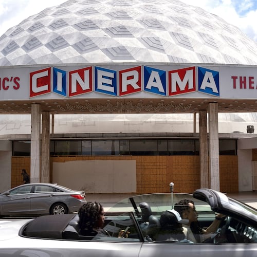 FILE - A motorist drives past the Cinerama Dome movie theater in Los Angeles on April 25, 2021. (AP Photo/Richard Vogel, File)