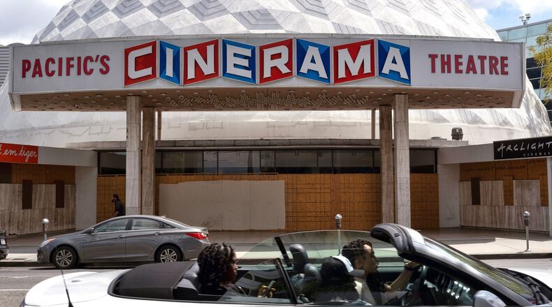 FILE - A motorist drives past the Cinerama Dome movie theater in Los Angeles on April 25, 2021. (AP Photo/Richard Vogel, File)