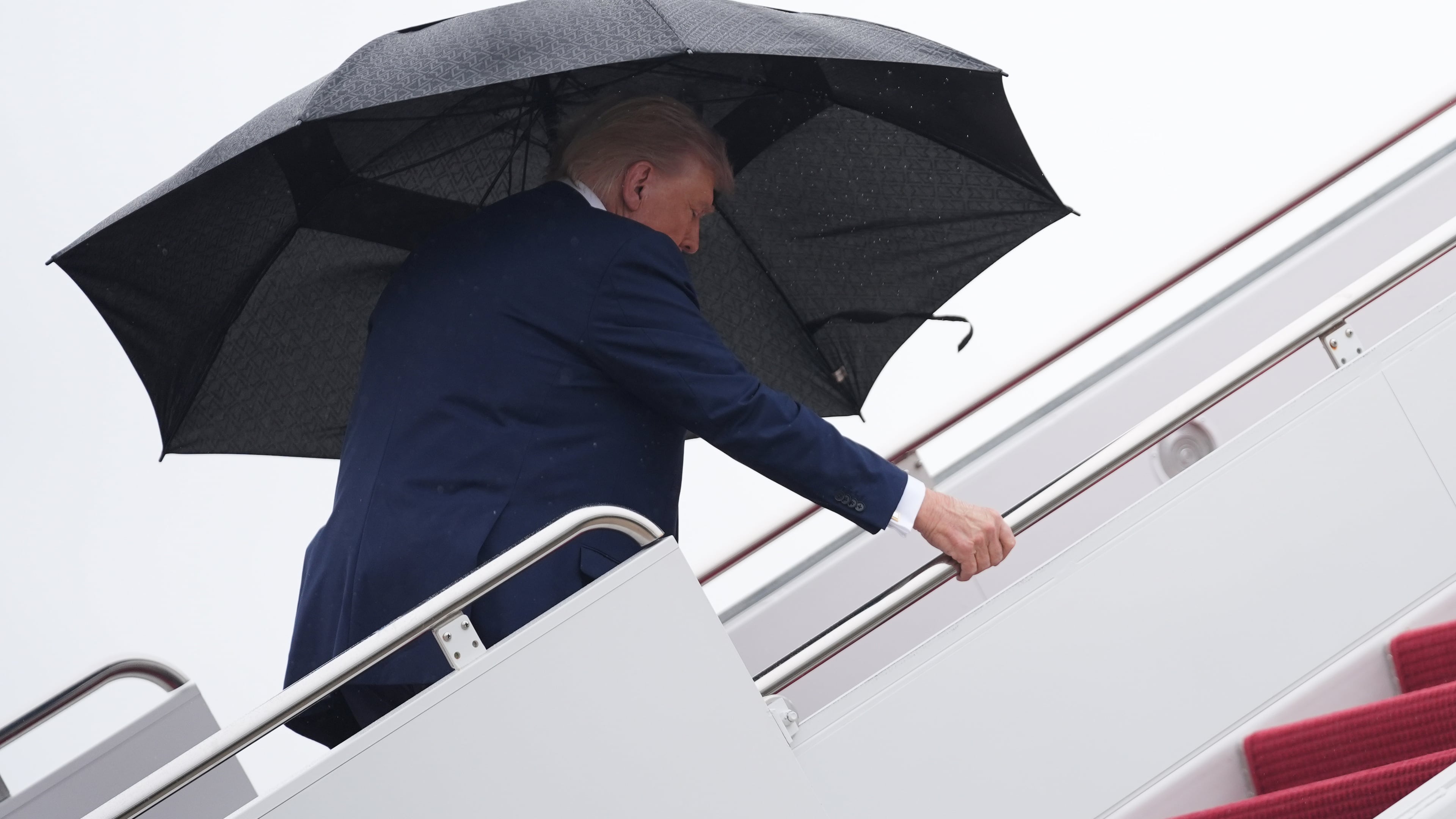 President Donald Trump boards Air Force One, Sunday, Oct. 12, 2025, at Joint Base Andrews, Md.., as he heads to the Middle East. (AP Photo/Evan Vucci)