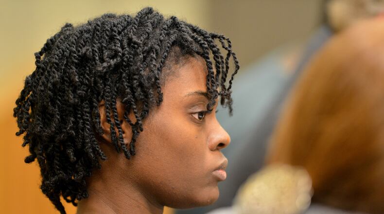 Tiffany Moss listens to testimony during court hearing in 2013. (KENT D. JOHNSON / KDJOHNSON@AJC.COM)