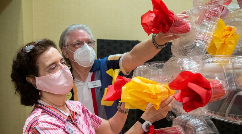 Mary & Vince Capka spruce up a 6-foot diameter Pop Art rendering of the COVID-19 virus they made with four other residents. The group decided they wanted to put a new face on the ongoing shelter in place mandates for seniors brought on by the Covid-19 pandemic. For months they have been served food in plastic containers in their apartments. Transplant recipient & strong believe in recycling, Mary Capka decided to collect these plastic items in hopes of finding a future use. Along with her husband & four other residents they devised a plan to commemorate their pandemic experience by building their air work. PHIL SKINNER FOR THE ATLANTA JOURNAL-CONSTITUTION.