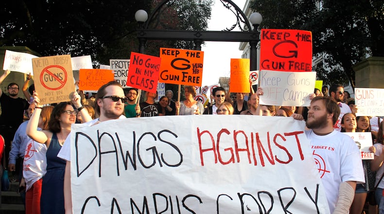 Protesters against campus carry last year at the University of Georgia arch. TAYLOR CARPENTER / TAYLOR.CARPENTER@AJC.COM