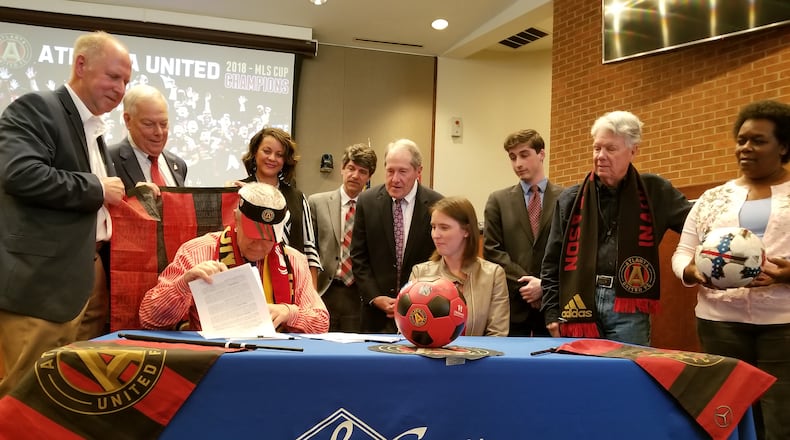 Marietta Mayor Steve Tumlin signs the contract to sell 17 acres to Atlanta United following Thursday's called City Council meeting.