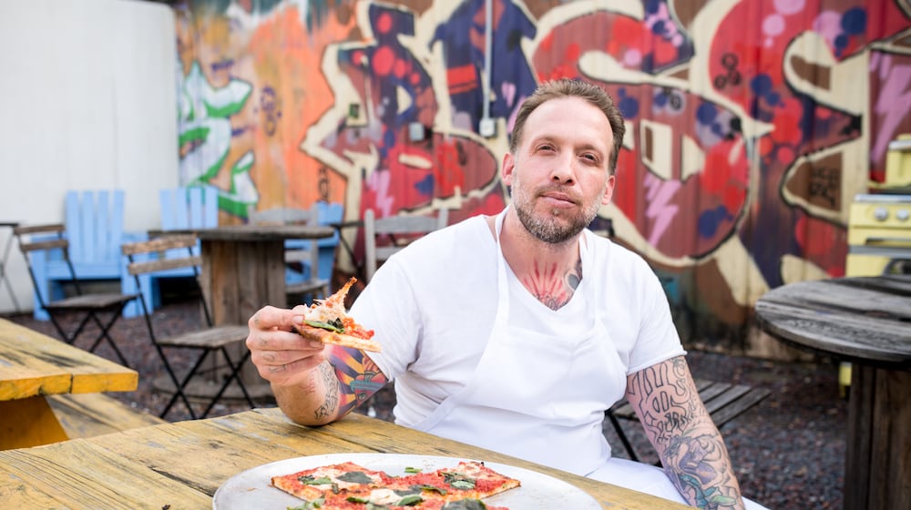 Anthony Spina enjoying the Grandma Pie at O4W Pizza. Photo Credit- Mia Yakel.