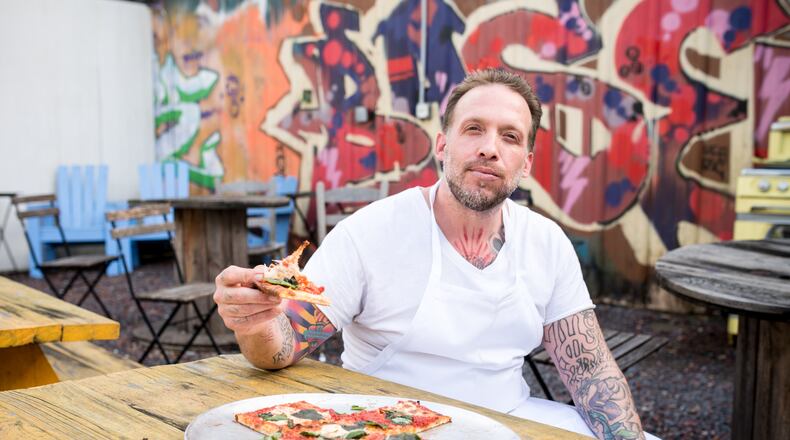 Anthony Spina enjoying the Grandma Pie at O4W Pizza. Photo Credit- Mia Yakel.