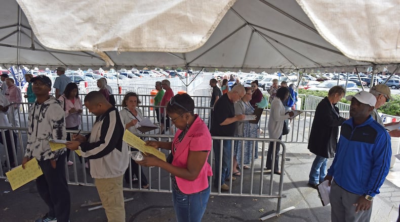 People lined up for early voting in Gwinnett County. Georgia purged more than 600,000 people from voter rolls in 2017. HYOSUB SHIN / HSHIN@AJC.COM