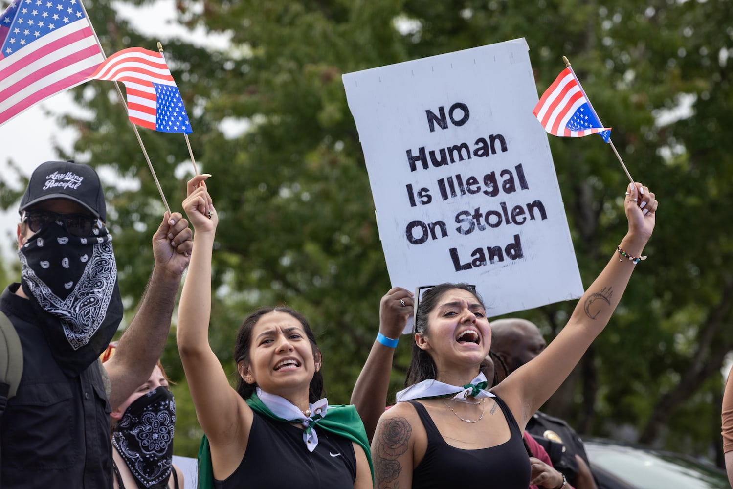 Demonstrators chant as police block their marching route during a protest on ICE raids and deportation arrests on Chamblee Tucker Road in Atlanta on Saturday, June 14, 2025. (Arvin Temkar / AJC)