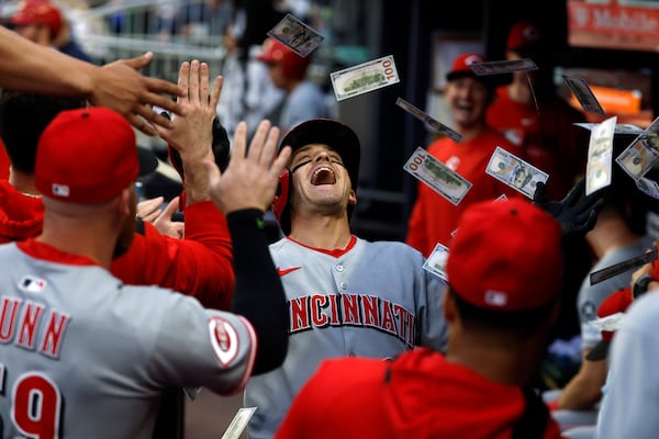 Cincinnati Reds' TJ Friedl celebrates with teammates after hitting a home run during the third inning of a baseball game against the Atlanta Braves, Wednesday, May 7, 2025, in Atlanta. (AP Photo/Butch Dill)
