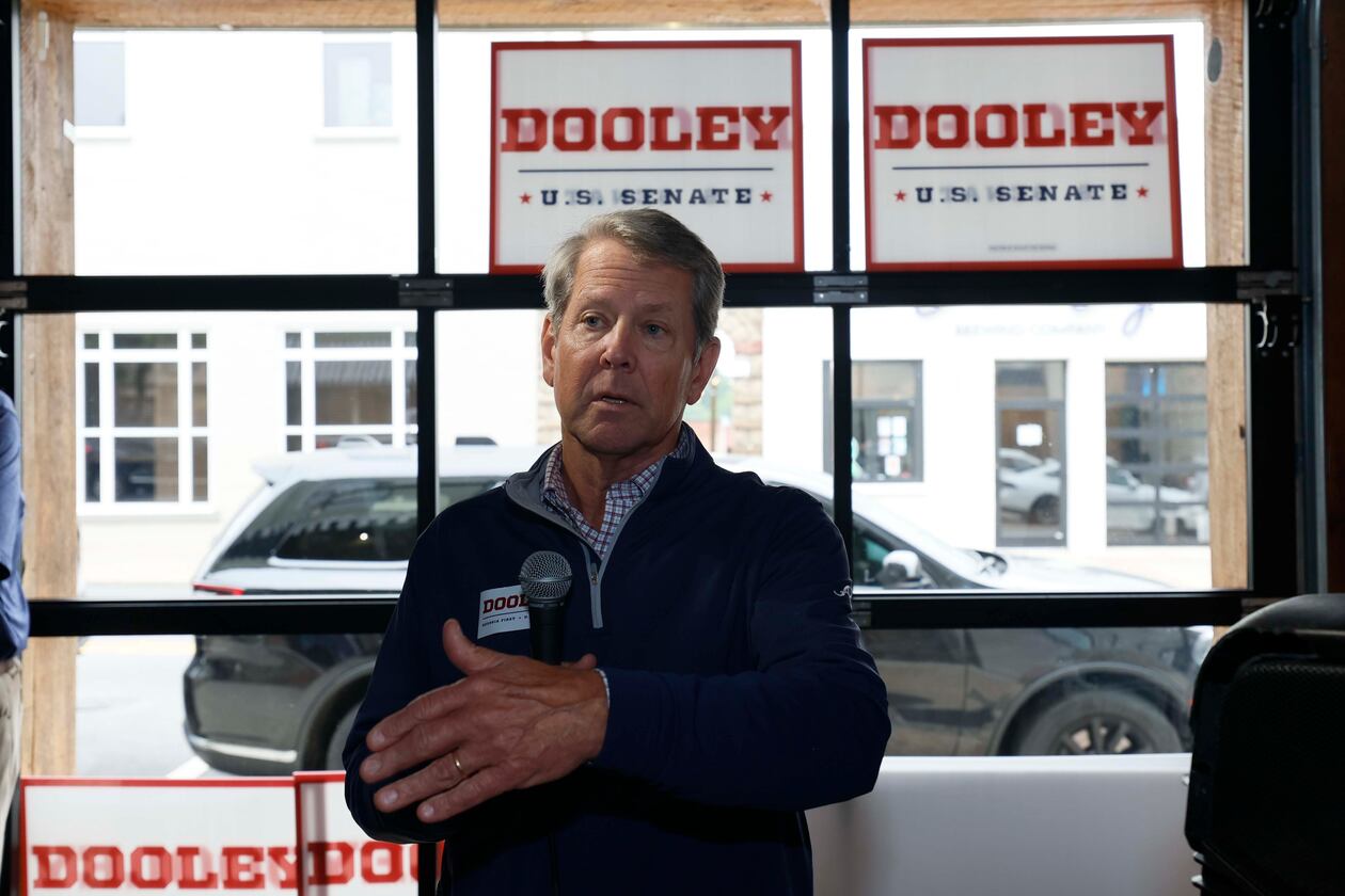 Gov. Brian Kemp addresses supporters while campaigning for U.S. Senate candidate Derek Dooley in downtown Carrollton on Monday. (Miguel Martinez/AJC)
