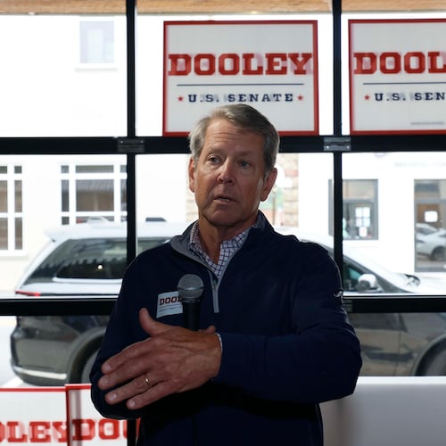 Gov. Brian Kemp addresses supporters while campaigning for U.S. Senate candidate Derek Dooley in downtown Carrollton on Monday. (Miguel Martinez/AJC)