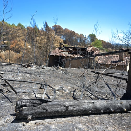 A gate and villa are burned after wildfires in Cotignac, France, Thursday, Aug. 6, 2026, as drought conditions worsen following a heatwave and water shortages across much of France. (AP Photo/Philippe Magoni)