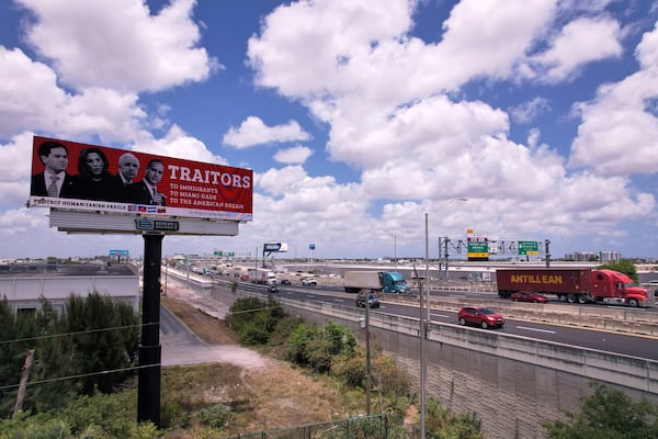 Vehicles on the Palmetto Expressway drive past a digital billboard reading "Traitors, to immigrants, to Miami-Dade, to the American dream," alongside pictures of Florida politicians with roots in Cuba, including from left, Secretary of State Marco Rubio, and U.S. Reps. Maria Elvira Salazar, Carlos Gimenez, and Mario Diaz-Balart, Friday, April 25, 2025, in Medley, Fla. (AP Photo/Rebecca Blackwell)