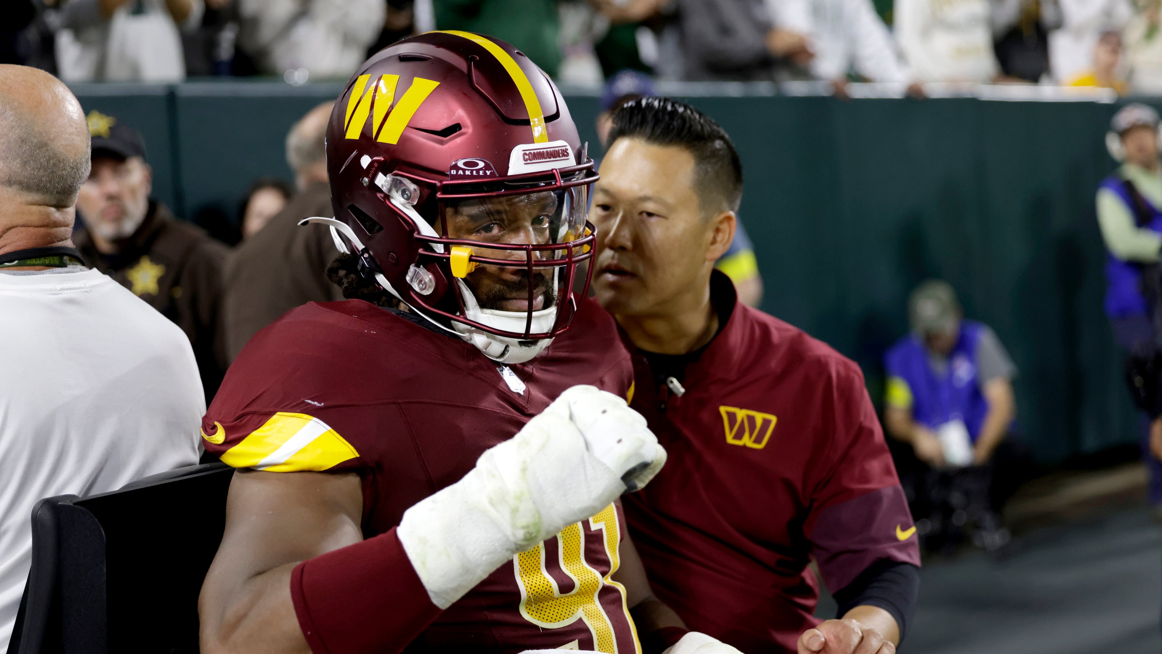 Washington Commanders defensive end Deatrich Wise (91) is taken off on a cart after being injured during the first half of an NFL football game against the Green Bay Packers Thursday, Sept. 11, 2025, in Green Bay, Wis.(AP Photo/Matt Ludtke)