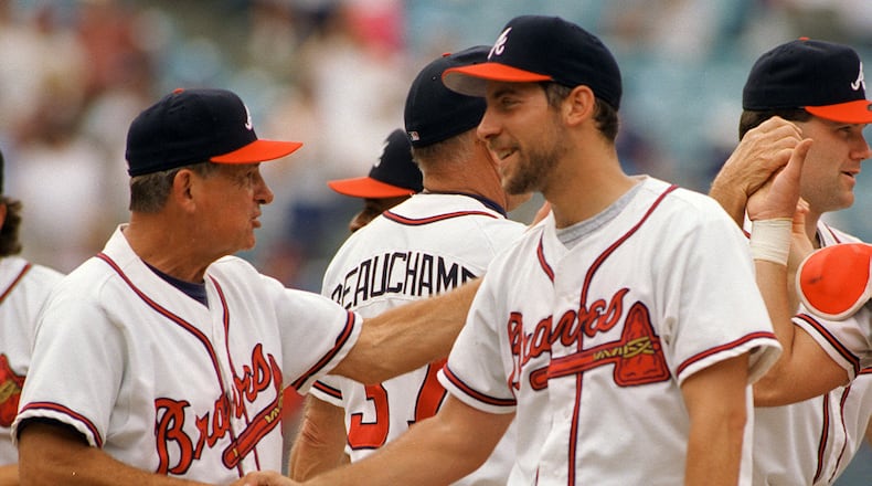 John Smoltz gets a handshake from Atlanta Braves manager Bobby Cox after completing his fourteenth straight win.