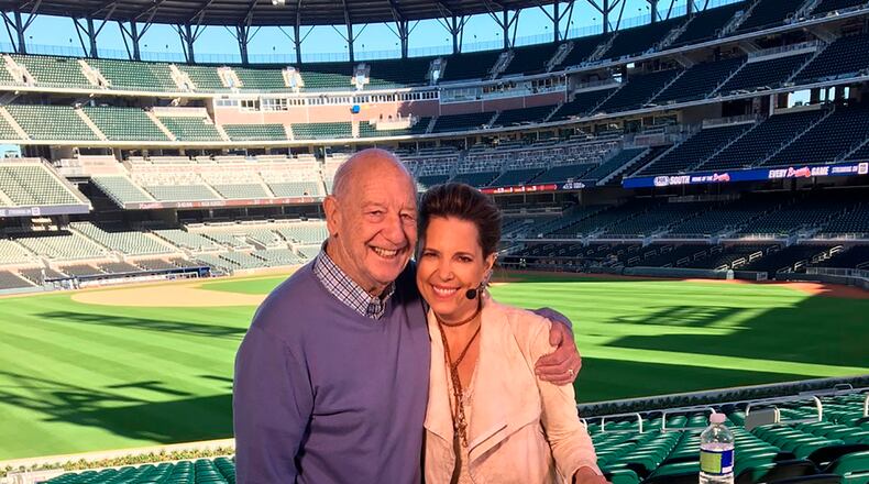 In this March 2017 photo provided by Hannah Storm, Mike Storen poses with daughter Hannah Storm at the Atlanta Braves' new ballpark in Atlanta. Storen, a former ABA commissioner and multisport marketing whiz, died Thursday, May 7, 2020. He was 84. Storm said her father died at Emory University Hospital in Atlanta of complications from cancer. (Courtesy of Hannah Storm via AP)