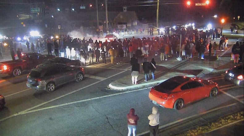 Spectators recording, posting video of street racing in Gwinnett could possibly land in jail. Johns Creek has passed a similar ordinance. AJC File
