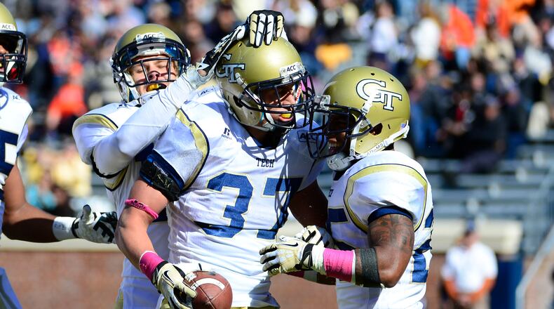 Georgia Tech Yellow Jackets running back Zach Laskey (37) celebrates with wide receiver Corey Dennis (16) and running back Robert Godhigh (25) after scoring a touchdown in the second quarter at Scott Stadium. Mandatory Credit: Bob Donnan-USA TODAY Sports