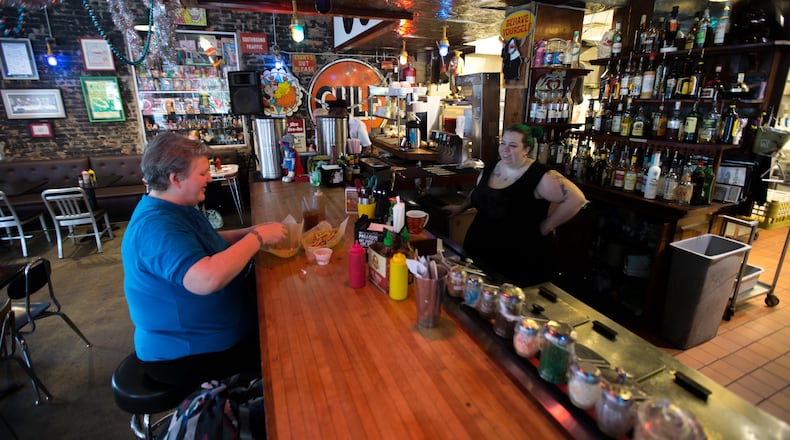 Marnie Bell-Ferguson, left, talks with bartender Jessica Woody at Pallookaville Fine Foods, Monday, Dec. 14, 2015, in Avondale Estates. BRANDEN CAMP/SPECIAL