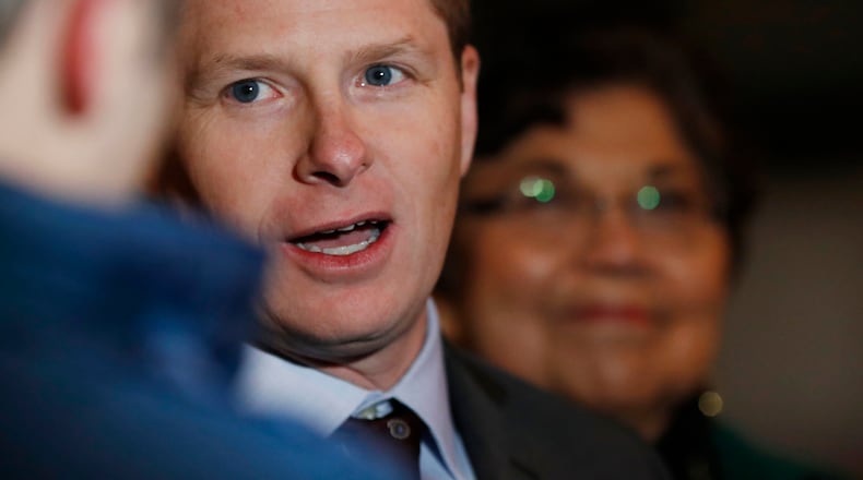 Attorney Jason Wesoky, front, responds to questions as Polly Baca, back, looks on after arguments in a lawsuit were heard Monday, Dec. 12, 2016, outside the federal courthouse in downtown Denver. Two Democratic electors are trying to be freed of Colorado's requirement that they vote for the winner of the state's popular vote in the presidential election this past November. (AP Photo/David Zalubowski)