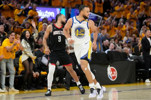 Golden State Warriors guard Stephen Curry (30) reacts after making a 3-point basket in front of Houston Rockets forward Dillon Brooks (9) during the second half of Game 3 of an NBA basketball first-round playoff series in San Francisco, Saturday, April 26, 2025. (AP Photo/Jeff Chiu)