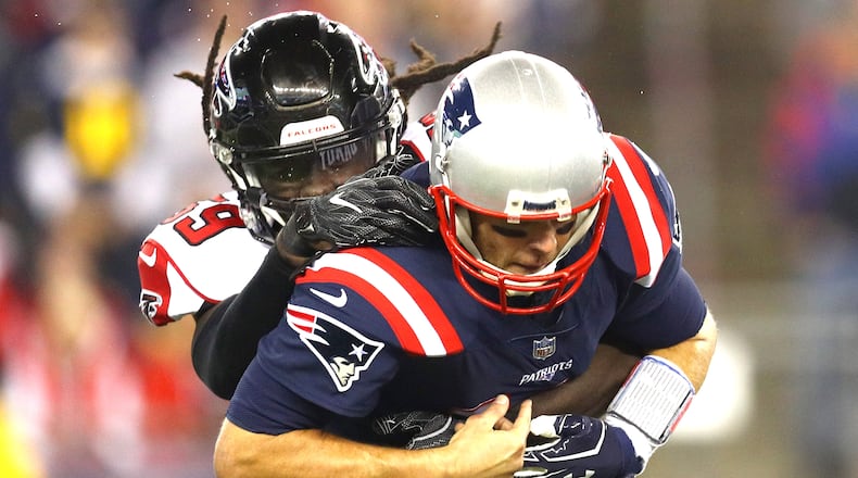 Falcons linebacker De'Vondre Campbell sacks Patriots quarterback Tom Brady in the first quarter of Sunday night's game at Gillette Stadium in Foxboro, Massachusetts.
