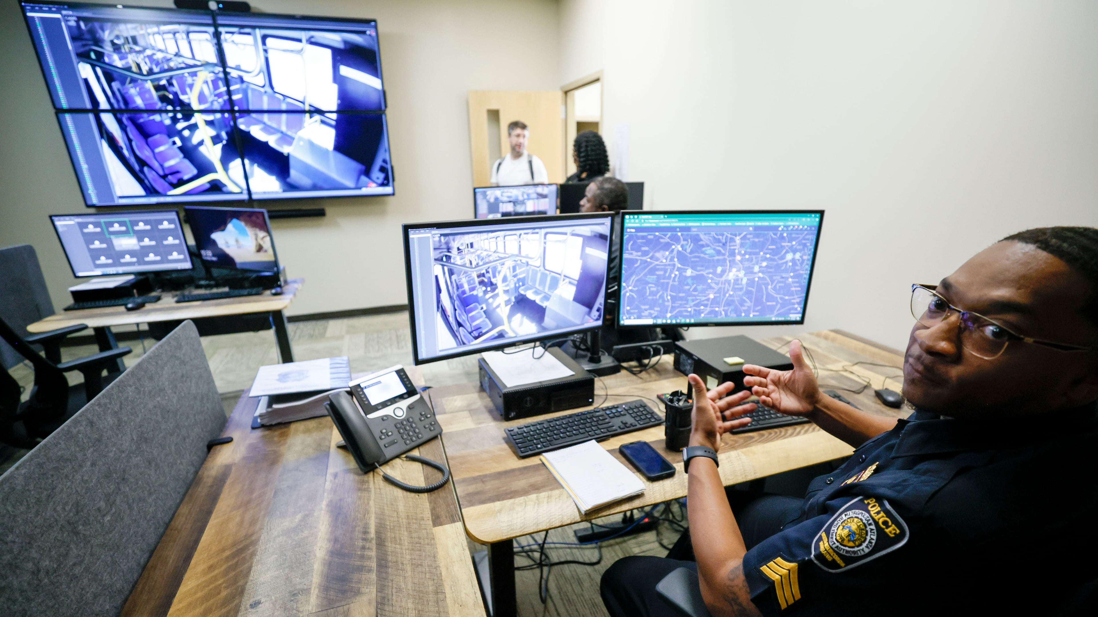 Sgt. Demetrius Garmon with MARTA police explains how he monitors activities on MARTA buses using a real-time system that operates multiple cameras from one of the operation centers at the Emergency Communication Center on Thursday, May 1, 2025. (Miguel Martinez/AJC)