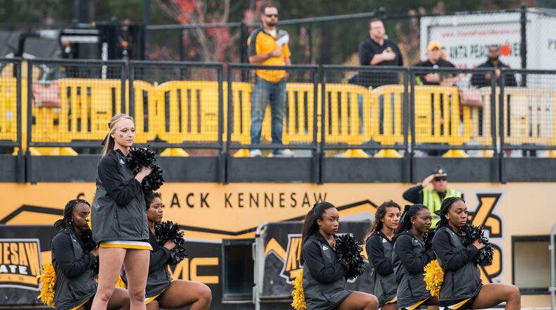 Some of the Kennesaw State cheerleaders resumed taking a knee during the national anthem at the Nov. 18 home game. On the previous Saturday, which was Veterans Day and the cheerleaders’ first time on the field for the anthem since the kneeling controversy began, none of the cheerleaders took a knee. Photo: Cory Hancock / Special to the AJC