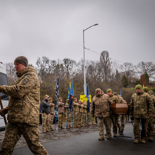 Servicemen carry the coffin of volunteer soldier Yukhym Agafontsev, 22, killed in a battle with the Russian troops, during a farewell ceremony in Kyiv, Ukraine, Tuesday, Dec. 2, 2025. (AP Photo/Dan Bashakov)