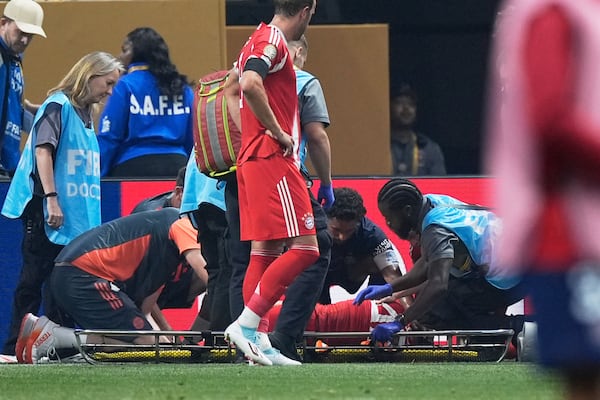 Bayern Munich's Harry Kane watches Bayern Munich's Jamal Musiala getting medical assistance during the Club World Cup quarterfinal soccer match between PSG and Bayern Munich in Atlanta, Saturday, July 5, 2025. (AP Photo/Mike Stewart)