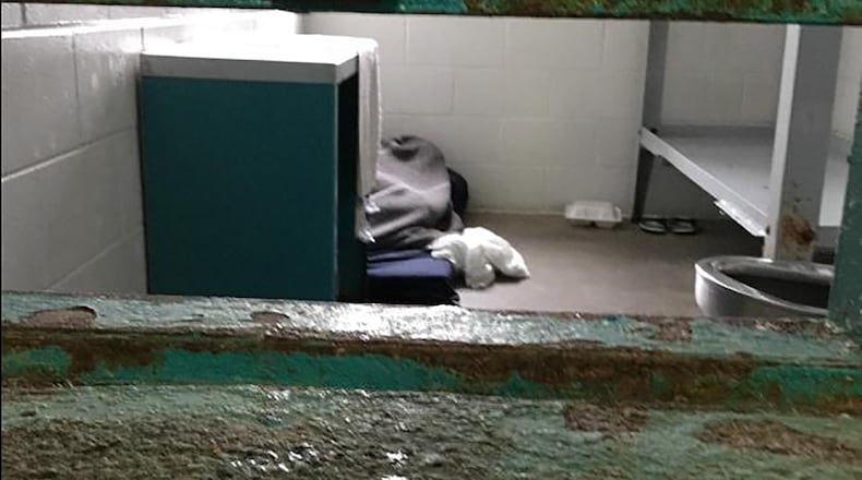 This corroded cell door flap — used to deliver food and medication to inmates — at the South Fulton Municipal Regional Jail is typical of unhealthy conditions at the jail, according to a federal lawsuit filed by the the Georgia Advocacy Office and two women being held there. The lawsuit includes graphic photos from a recent visit to the jail and details unimaginable conditions for the women detainees. (Photo from the lawsuit filed Wednesday in U.S. District Court in Atlanta)