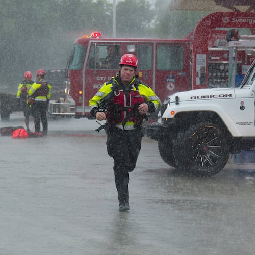 Members of the Boerne Fire Dept. prepare to perform a water rescue on Wednesday, July 15, 2026, in Boerne, Texas. (AP Photo/Darren Abate)