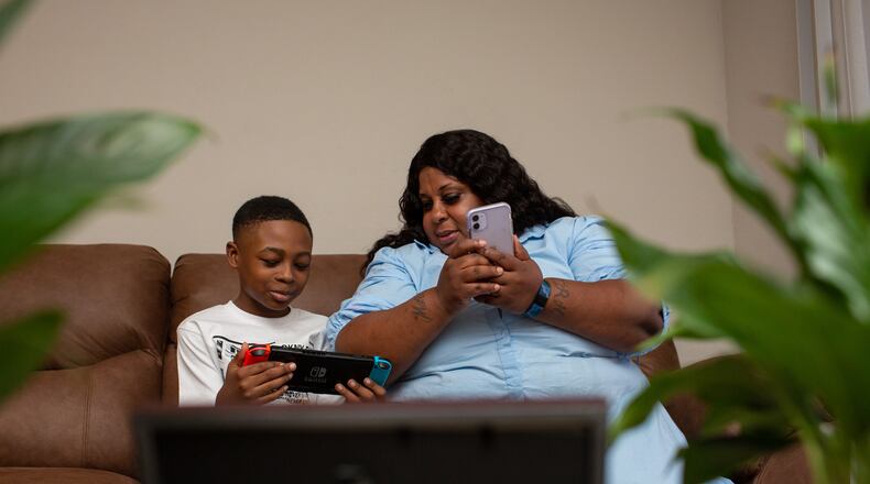 Tiwanda Evans spends the afternoon with her grandson Ralph Jackson at her apartment in Hunter’s Grove Apartments in Austell on Tuesday, February 23, 2021. Because of her asthma and diabetes, health care worker Evans hasn’t been able to work her regular job and has struggled to pay her rent. (Rebecca Wright for The Atlanta Journal-Constitution)