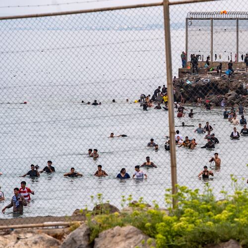 Migrants try to cross from Morocco into the Spanish enclave of Ceuta, Friday, July 31, 2026. (AP Photo/Antonio Sempere)