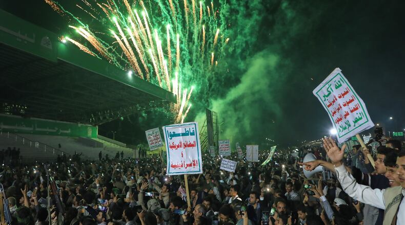 Fireworks burst as Houthi supporters rally against the Saudi-led coalition in Sanaa, Yemen, Monday, July 20, 2026. Placards in Arabic read: "God is great, Death to America, Death to Israel, A curse on the Jews and Victory to Islam" and "boycott American and Israeli goods". (AP Photo/Osamah Abdulrahman)