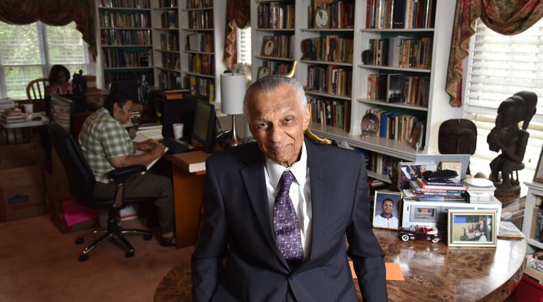 Portrait of C.T. Vivian at his home library as his daughter Charisse Thornton (background) and Dawnn Mitchell work on checking inventory on Tuesday, July 25, 2017. The National Monuments Foundation will be acquiring and managing the world-class library of Atlanta Civil Rights icon, C.T. Vivian. The library will be housed in the new Cook Park in Vine City. Vivian lived in the same Vine City neighborhood that will border Cook Park where his library is to be constructed under a 101-foot Peace Column. The 6,000 volume C.T. Vivian Library is one of the most impressive private collections in the city. HYOSUB SHIN / HSHIN@AJC.COM