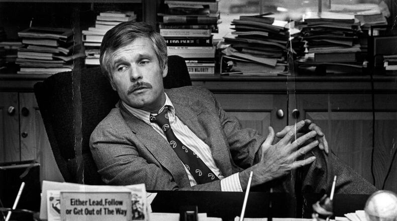 Ted Turner is seen at his desk inside the CNN Center in 1982. (Nancy Mangiafico/AJC)