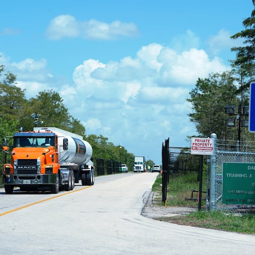 FILE - Trucks come and go from the "Alligator Alcatraz" immigration detention center in the Florida Everglades, Aug. 28, 2025, in Collier County, Fla. (AP Photo/Rebecca Blackwell, File)