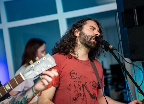 Bon House is a residential venue for live music, where Tongues of Fire, including lead singer and guitarist Lowell Hobbs, performs with the band in Decatur on March 19.  (Jenni Girtman for The Atlanta Journal-Constitution)
