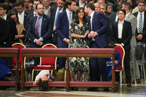U.S. Vice President JD Vance, and his wife Usha Vance, center, with their daughter Mirabel attend a Good Friday service inside St. Peter's Basilica at the Vatican, Friday, April 18, 2025. (AP Photo/Alessandra Tarantino)